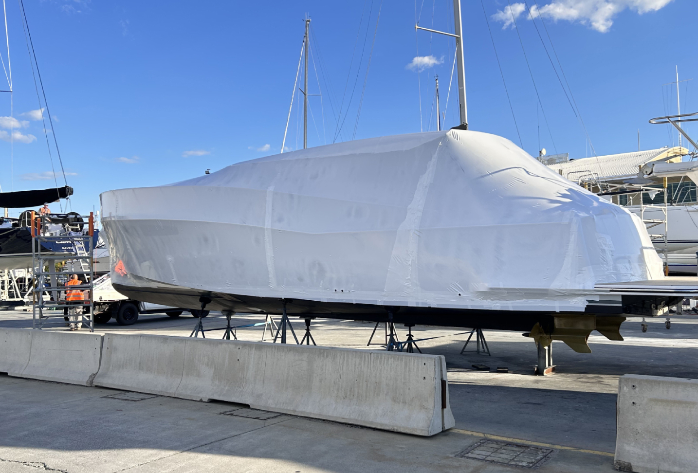Completed Tufwrap marine containment system on composite yacht hull, fully sealed for refit projects